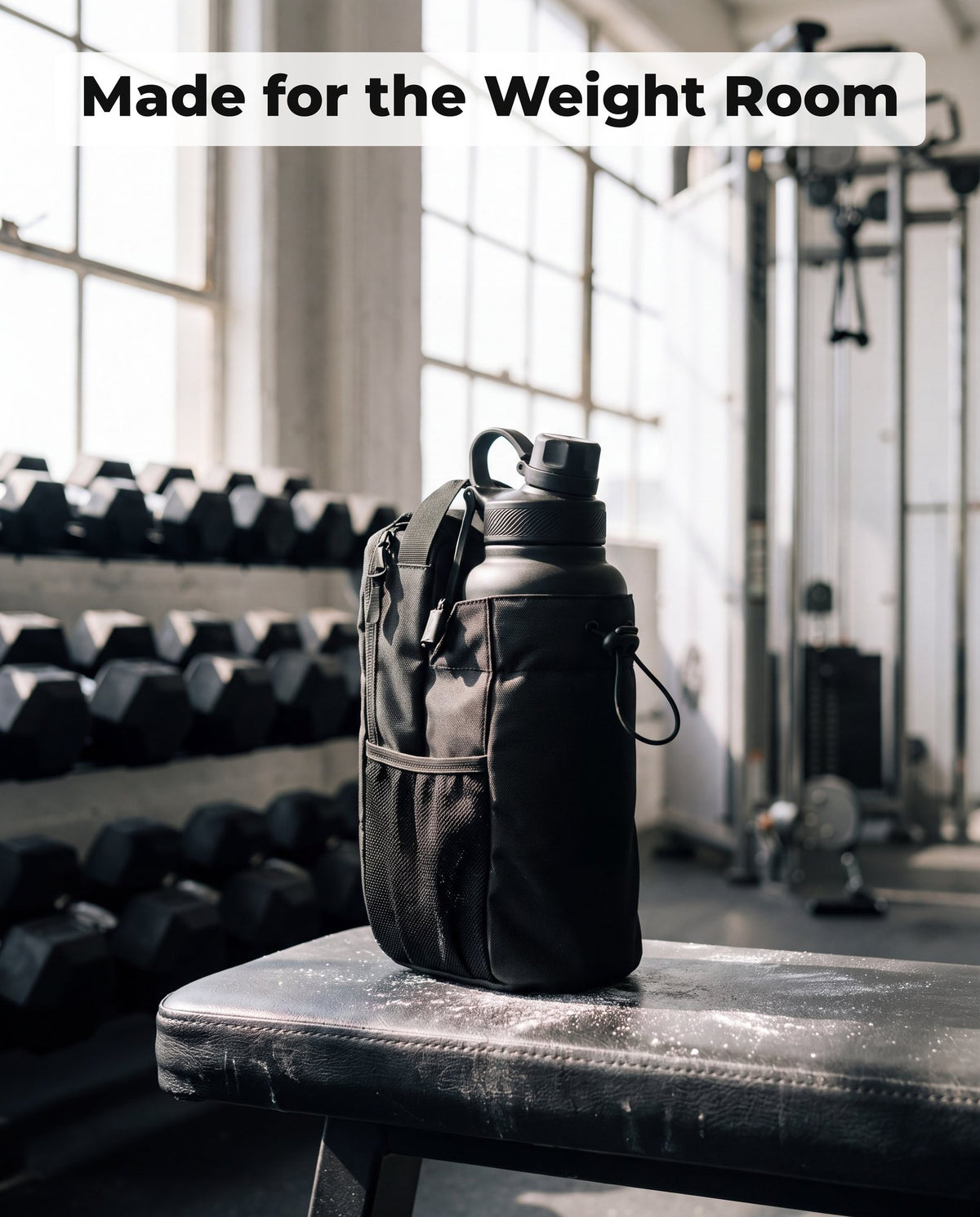 Black bottle bag with a matte black bottle on a dark grey studio background